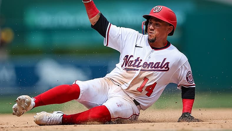Aug 14, 2022; Washington, District of Columbia, USA; Washington Nationals shortstop Ildemaro Vargas (14) slides into third base and is returned during the eighth inning of the game against the San Diego Padres at Nationals Park. Mandatory Credit: Scott Taetsch-USA TODAY Sports