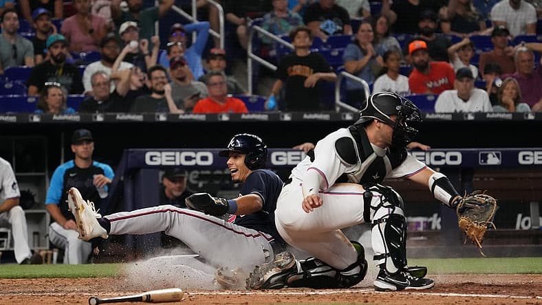 Aug 14, 2022; Miami, Florida, USA; Atlanta Braves second baseman Vaughn Grissom (18) scores a run behind Miami Marlins catcher Nick Fortes (54) on the single of catcher William Contreras (not pictured) in the ninth inning at loanDepot park. Mandatory Credit: Jasen Vinlove-USA TODAY Sports