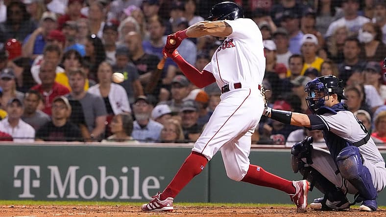 Aug 14, 2022; Boston, Massachusetts, USA; Boston Red Sox left fielder Tommy Pham (22) hits a single against the New York Yankees during the sixth inning at Fenway Park. Mandatory Credit: Gregory Fisher-USA TODAY Sports