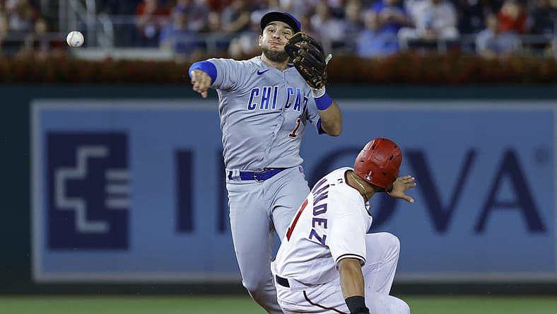 Aug 15, 2022; Washington, District of Columbia, USA; Chicago Cubs second baseman Nick Madrigal (1) attempts to turn a double play from second base ahead of the slide of Washington Nationals second baseman Cesar Hernandez (1) during the fifth inning at Nationals Park. Mandatory Credit: Geoff Burke-USA TODAY Sports