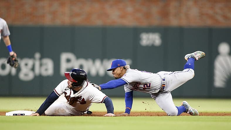 Aug 15, 2022; Atlanta, Georgia, USA; New York Mets shortstop Francisco Lindor (12) tags out Atlanta Braves catcher Travis d'Arnaud (16) at second base in the second inning at Truist Park. Mandatory Credit: Brett Davis-USA TODAY Sports