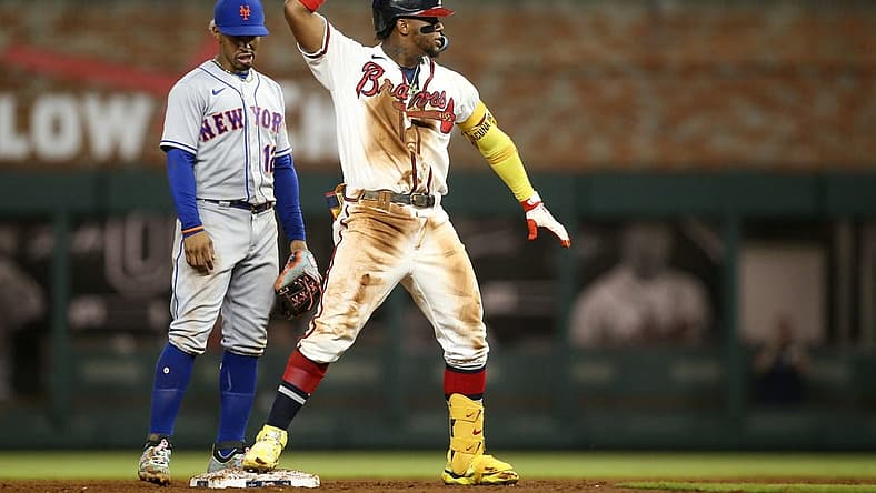 Aug 15, 2022; Atlanta, Georgia, USA; Atlanta Braves right fielder Ronald Acuna Jr. (13) celebrates after a RBI double in front of New York Mets shortstop Francisco Lindor (12) in the sixth inning at Truist Park. Mandatory Credit: Brett Davis-USA TODAY Sports