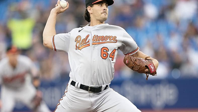 Aug 16, 2022; Toronto, Ontario, CAN; Baltimore Orioles starting pitcher Dean Kremer (64) throws a pitch against the Toronto Blue Jays during the first inning at Rogers Centre. Mandatory Credit: Nick Turchiaro-USA TODAY Sports