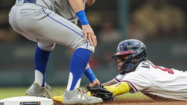 Aug 16, 2022; Cumberland, Georgia, USA; Atlanta Braves right fielder Ronald Acuna Jr. (13) is tagged out by New York Mets second baseman Jeff McNeil (1) while trying to steal during the first inning at Truist Park. Mandatory Credit: Dale Zanine-USA TODAY Sports