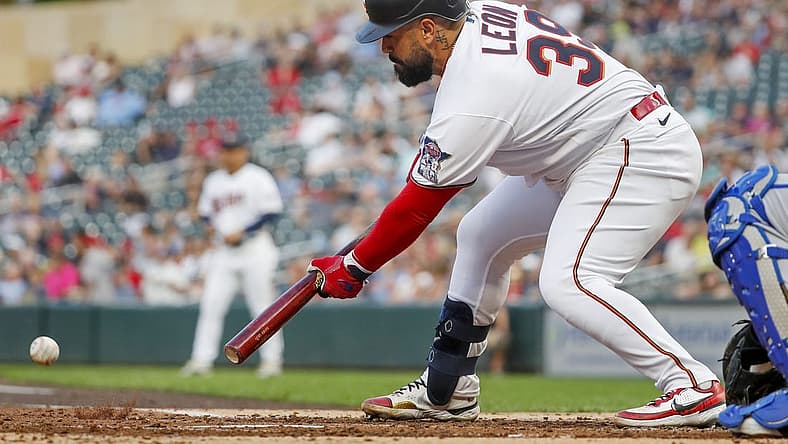 Aug 16, 2022; Minneapolis, Minnesota, USA; Minnesota Twins catcher Sandy Leon (39) lays down an RBI sacrifice bunt against the Kansas City Royals in the first inning at Target Field. Mandatory Credit: Bruce Kluckhohn-USA TODAY Sports