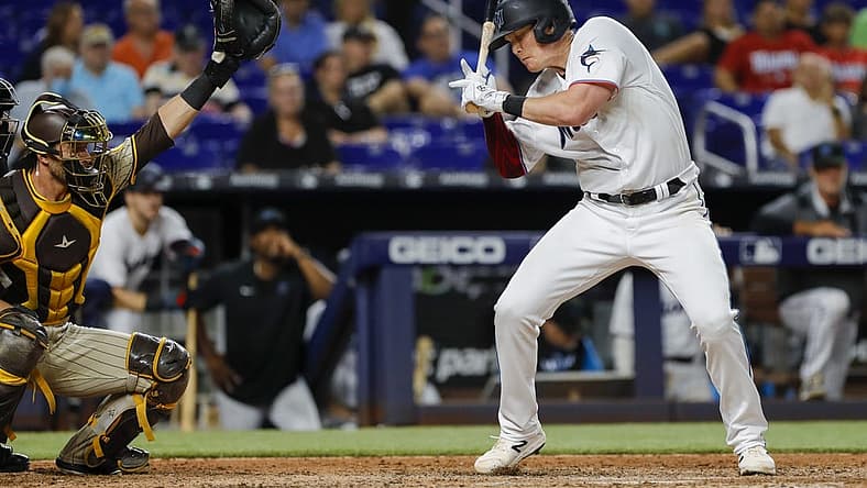 Aug 16, 2022; Miami, Florida, USA; Miami Marlins first baseman Garrett Cooper (26) reacts after getting hit by a pitch during the eighth inning against the San Diego Padres at loanDepot Park. Mandatory Credit: Sam Navarro-USA TODAY Sports