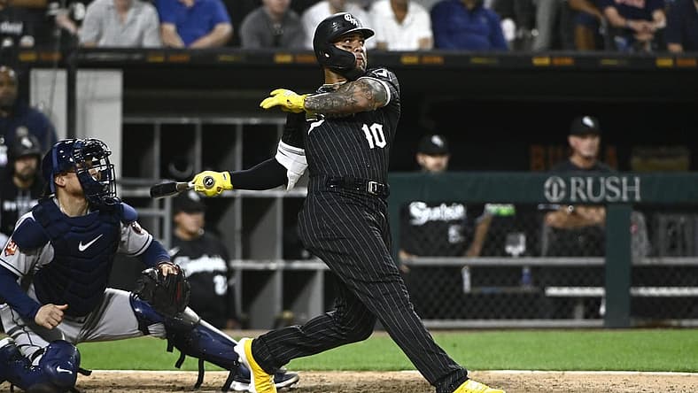 Aug 16, 2022; Chicago, Illinois, USA; Chicago White Sox third baseman Yoan Moncada (10) hits an RBI single against the Houston Astros during the eighth inning at Guaranteed Rate Field. Mandatory Credit: Matt Marton-USA TODAY Sports