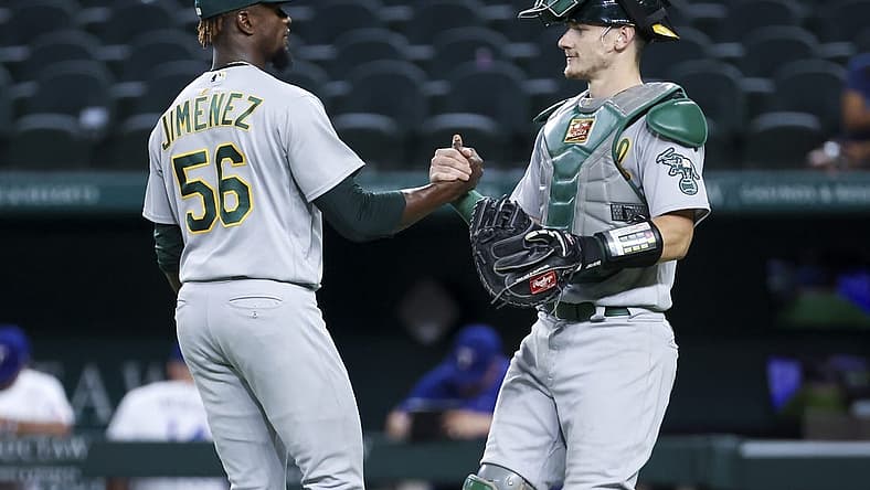Aug 16, 2022; Arlington, Texas, USA; Oakland Athletics relief pitcher Dany Jimenez (56) celebrates with Oakland Athletics catcher Sean Murphy (12) after the game against the Texas Rangers at Globe Life Field. Mandatory Credit: Kevin Jairaj-USA TODAY Sports