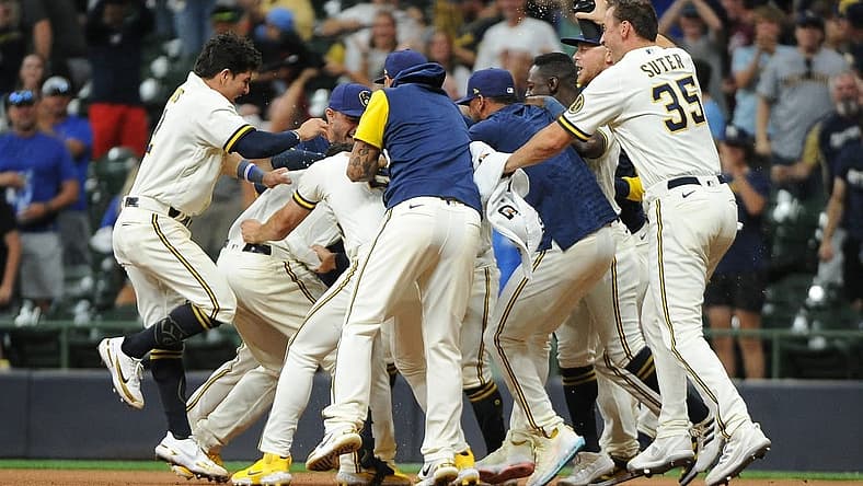 Aug 16, 2022; Milwaukee, Wisconsin, USA; The Milwaukee Brewers celebrate around catcher Victor Caratini (7) after a game winning hit against the Los Angeles Dodgers in the eleventh inning at American Family Field. Final Milwaukee Brewers 5, Los Angeles Dodgers 4. Mandatory Credit: Michael McLoone-USA TODAY Sports