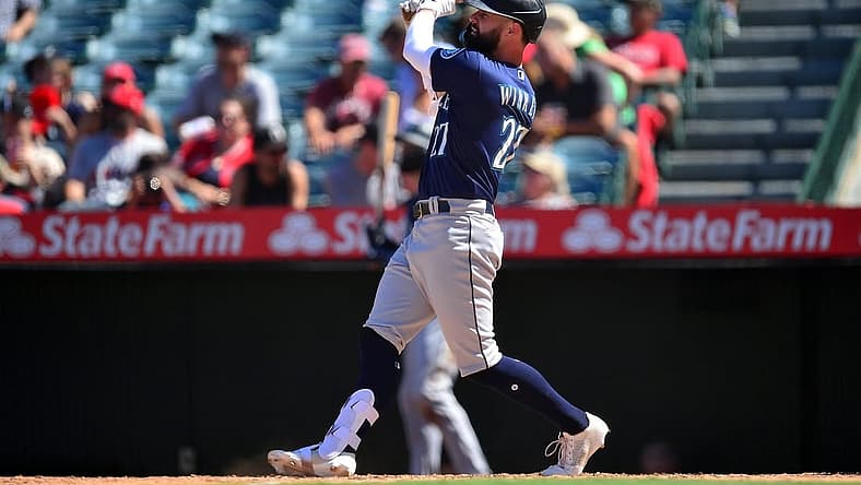 Aug 17, 2022; Anaheim, California, USA; Seattle Mariners designated hitter Jesse Winker (27) hits a two run home run against the Los Angeles Angels during the sixth inning at Angel Stadium. Mandatory Credit: Gary A. Vasquez-USA TODAY Sports
