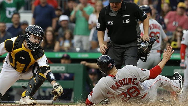 Aug 17, 2022; Pittsburgh, Pennsylvania, USA; Boston Red Sox designated hitter J.D. Martinez (28) slides into home to score a run as Pittsburgh Pirates catcher Jason Delay (61) attempts a tag during the second inning at PNC Park. Mandatory Credit: Charles LeClaire-USA TODAY Sports