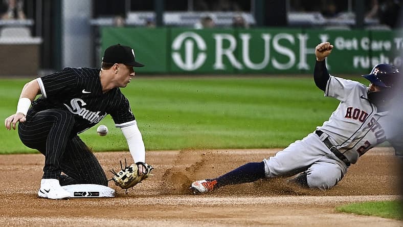 Aug 17, 2022; Chicago, Illinois, USA; Houston Astros second baseman Jose Altuve (27) slides safely into second base after a steal as Chicago White Sox shortstop Romy Gonzalez missed the tag during the first inning at Guaranteed Rate Field. Mandatory Credit: Matt Marton-USA TODAY Sports