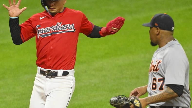 Aug 17, 2022; Cleveland, Ohio, USA; Cleveland Guardians second baseman Andres Gimenez (0) scores on a passed ball beside Detroit Tigers relief pitcher Jose Cisnero (67) in the sixth inning at Progressive Field. Mandatory Credit: David Richard-USA TODAY Sports