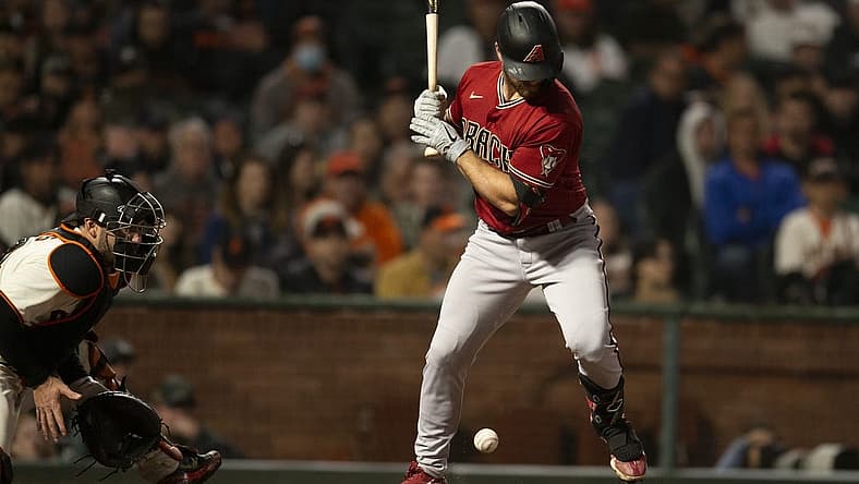 Aug 17, 2022; San Francisco, California, USA; Arizona Diamondbacks catcher Cooper Hummel (21) is hit by a pitch from San Francisco Giants starting pitcher Carlos Rod n during the sixth inning at Oracle Park. Mandatory Credit: D. Ross Cameron-USA TODAY Sports