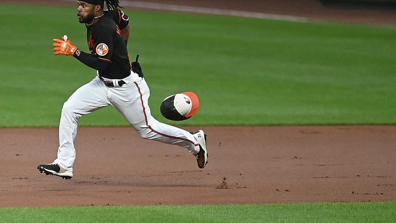 Aug 19, 2022; Baltimore, Maryland, USA; Baltimore Orioles center fielder Cedric Mullins (31) looses his helmet while running out a first inning doubler against the Boston Red Sox  at Oriole Park at Camden Yards. Mandatory Credit: Tommy Gilligan-USA TODAY Sports