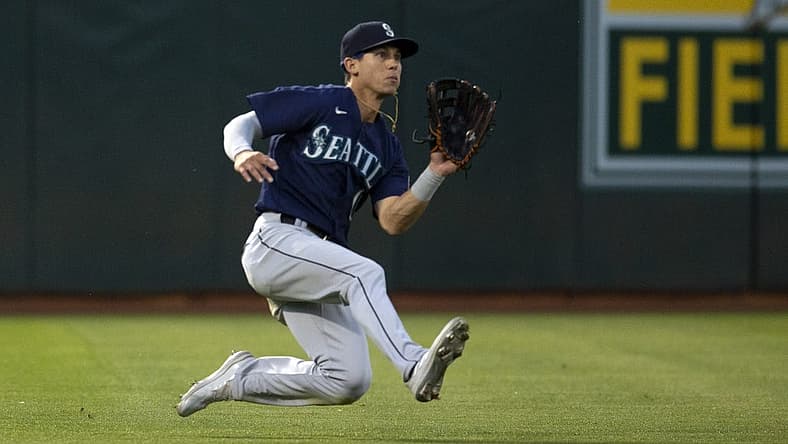 Aug 19, 2022; Oakland, California, USA; Seattle Mariners left fielder Sam Haggerty (0) makes a sliding catch against the Oakland Athletics during the fifth inning at RingCentral Coliseum. Mandatory Credit: D. Ross Cameron-USA TODAY Sports