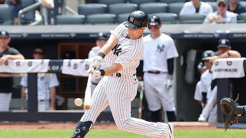 Aug 20, 2022; Bronx, New York, USA; New York Yankees left fielder Andrew Benintendi (18) hits a single against the Toronto Blue Jays during the first inning at Yankee Stadium. Mandatory Credit: Tom Horak-USA TODAY Sports
