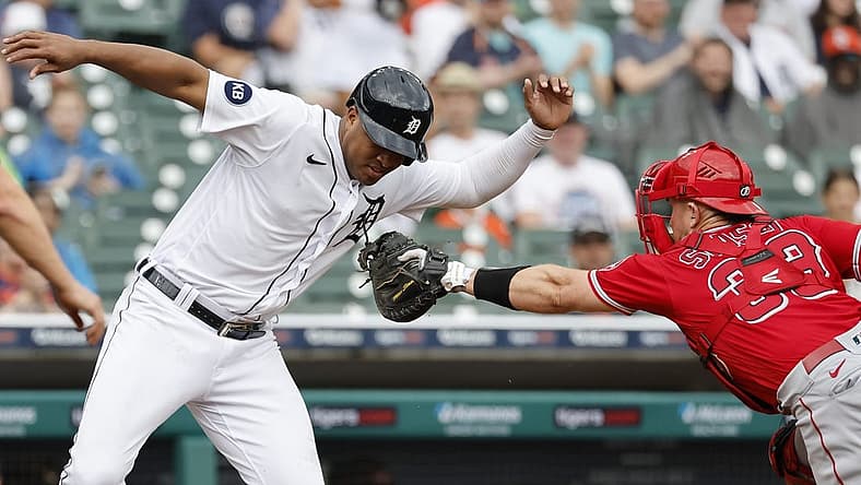 Aug 20, 2022; Detroit, Michigan, USA;  Detroit Tigers second baseman Jonathan Schoop (7) avoids the first tag by Los Angeles Angels catcher Max Stassi (33) in the third inning at Comerica Park. Mandatory Credit: Rick Osentoski-USA TODAY Sports