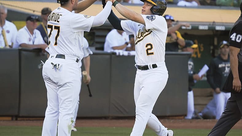 Aug 20, 2022; Oakland, California, USA; Oakland Athletics second baseman Jonah Bride (77) and shortstop Nick Allen (2) high five after being batted in against the Seattle Mariners during the fifth inning at RingCentral Coliseum. Mandatory Credit: Kelley L Cox-USA TODAY Sports