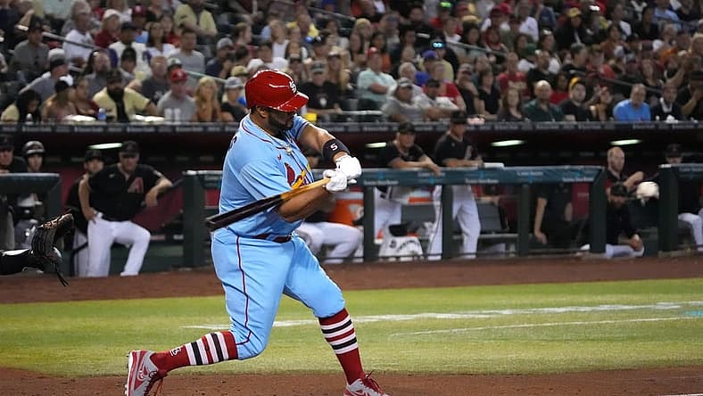 Aug 20, 2022; Phoenix, Arizona, USA; St. Louis Cardinals designated hitter Albert Pujols (5) hits a solo home run against the Arizona Diamondbacks during the fourth inning at Chase Field. Mandatory Credit: Joe Camporeale-USA TODAY Sports