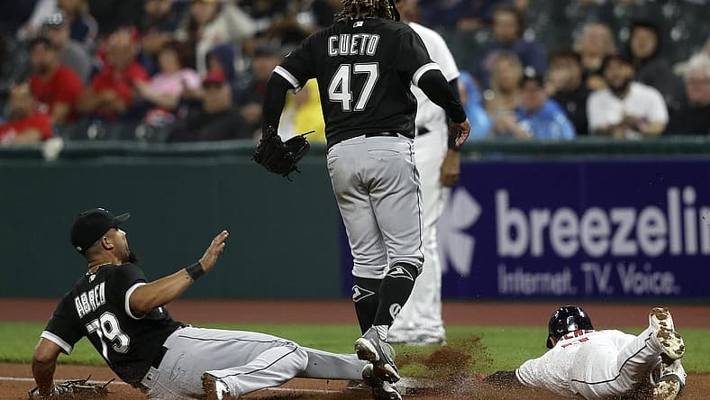 Aug 20, 2022; Cleveland, Ohio, USA; Chicago White Sox first baseman Jose Abreu (79) slides to first base to force out Cleveland Guardians Andres Gimenez (0) as pitcher Johnny Cueto jumps out of the way in the second inning at Progressive Field. Mandatory Credit: Aaron Josefczyk-USA TODAY Sports