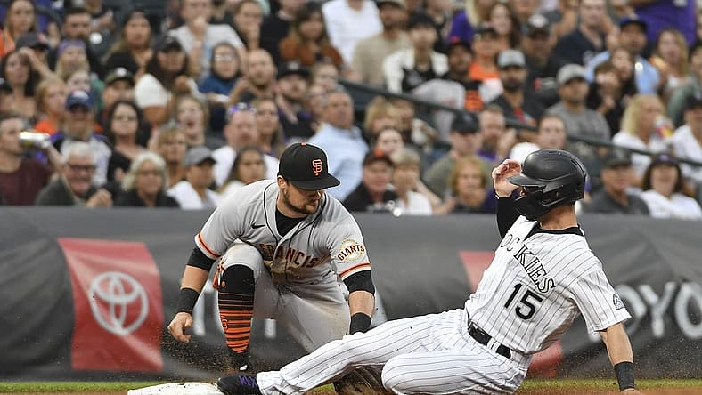 Aug 20, 2022; Denver, Colorado, USA; (Editors Notes: Caption Correction) Colorado Rockies right fielder Randal Grichuk (15) is tagged out by San Francisco Giants third baseman J.D. Davis (7) during the third inning at Coors Field. Mandatory Credit: John Leyba-USA TODAY Sports