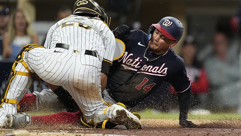 Aug 20, 2022; San Diego, California, USA; Washington Nationals third baseman Ildemaro Vargas (14) is tagged out at home plate by San Diego Padres catcher Austin Nola (26) during the fifth inning at Petco Park. Mandatory Credit: Ray Acevedo-USA TODAY Sports