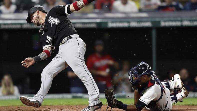 Aug 20, 2022; Cleveland, Ohio, USA; Chicago White Sox catcher Yasmani Grandal (24) is tagged out at home by Cleveland Guardians catcher Luke Maile (12) in the seventh inning at Progressive Field. Mandatory Credit: Aaron Josefczyk-USA TODAY Sports