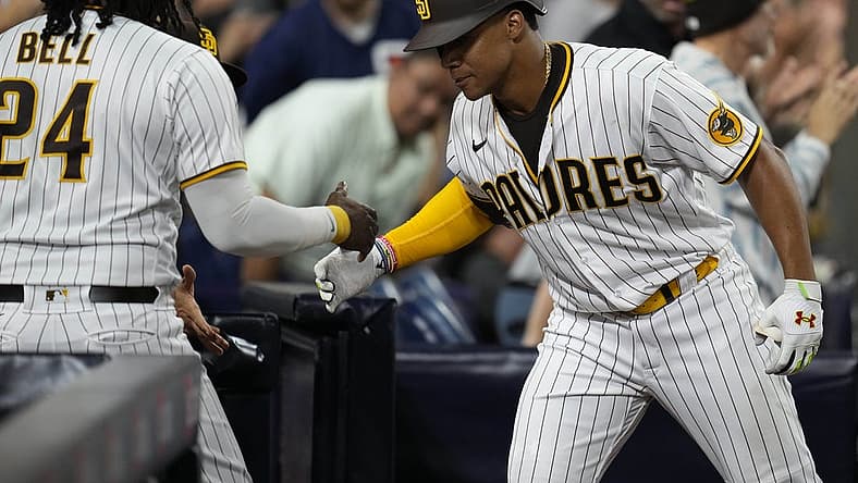 Aug 20, 2022; San Diego, California, USA; San Diego Padres right fielder Juan Soto (22) greets designated hitter Josh Bell (left) after hitting a home run during the seventh inning against the Washington Nationals at Petco Park. Mandatory Credit: Ray Acevedo-USA TODAY Sports