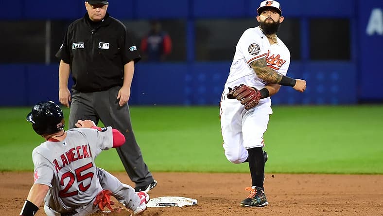 Aug 21, 2022; Williamsport, Pennsylvania, USA; Baltimore Orioles second baseman Rougned Odor (12) turns a double play over Boston Red Sox catcher Kevin Plawecki (25) in the third inning at Muncy Bank Ballpark at Historic Bowman Field. Mandatory Credit: Evan Habeeb-USA TODAY Sports
