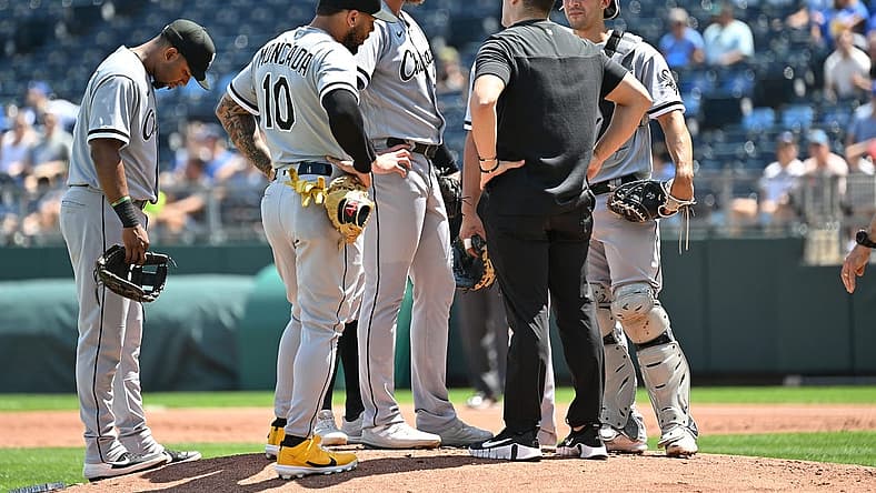 Aug 22, 2022; Kansas City, Missouri, USA;  Chicago White Sox starting pitcher Michael Kopech (34) talks with a trainer during the first inning against the Kansas City Royals at Kauffman Stadium. Mandatory Credit: Peter Aiken-USA TODAY Sports