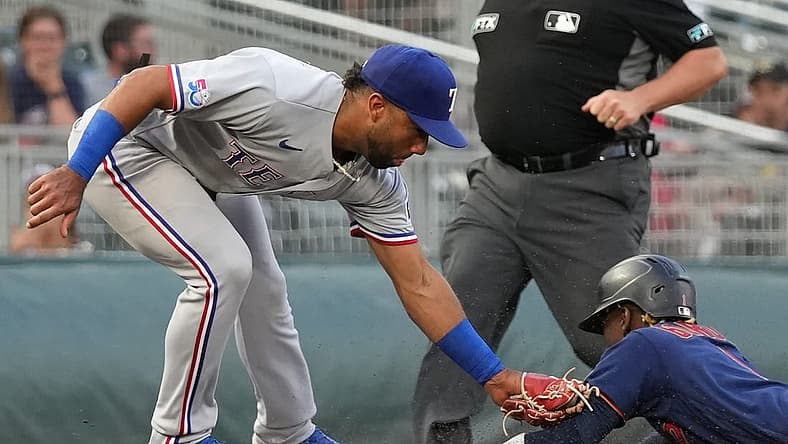 Aug 22, 2022; Minneapolis, Minnesota, USA; Minnesota Twins left fielder Nick Gordon (1) is tagged out by Texas Rangers third baseman Ezequiel Duran (70) after attempting to steal third base during the fourth inning at Target Field. Mandatory Credit: Jordan Johnson-USA TODAY Sports