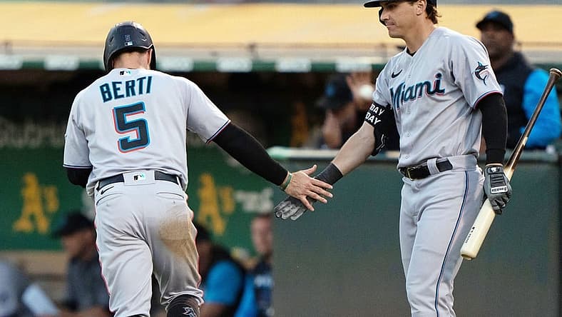 Aug 22, 2022; Oakland, California, USA; Miami Marlins second baseman Jon Berti (5) celebrates with center fielder JJ Bleday (67) during the third inning against the Oakland Athletics at RingCentral Coliseum. Mandatory Credit: Stan Szeto-USA TODAY Sports