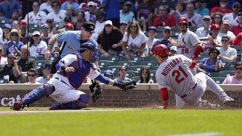 Aug 23, 2022; Chicago, Illinois, USA; Chicago Cubs catcher Yan Gomes (7) tags out St. Louis Cardinals right fielder Lars Nootbaar (21) during the first inning at Wrigley Field. Mandatory Credit: David Banks-USA TODAY Sports