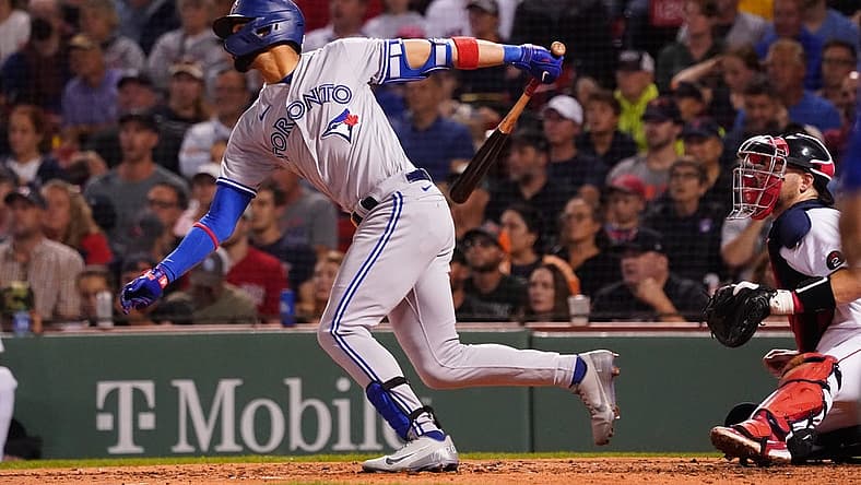 Aug 23, 2022; Boston, Massachusetts, USA; Toronto Blue Jays left fielder Lourdes Gurriel Jr. (13) hits a double to drive in a run against the Boston Red Sox in the third inning at Fenway Park. Mandatory Credit: David Butler II-USA TODAY Sports