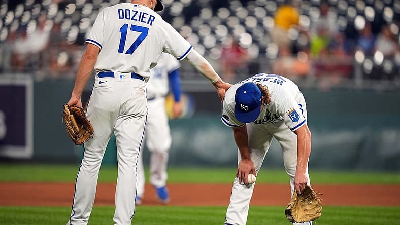 Aug 23, 2022; Kansas City, Missouri, USA; Kansas City Royals third baseman Hunter Dozier (17) talks with starting pitcher Jonathan Heasley (49) as he gets sick on the field during the fourth inning against the Arizona Diamondbacks at Kauffman Stadium. Mandatory Credit: Jay Biggerstaff-USA TODAY Sports