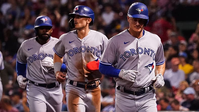Aug 23, 2022; Boston, Massachusetts, USA; Toronto Blue Jays third baseman Matt Chapman (26), first baseman Cavan Biggio (8) and right fielder Jackie Bradley Jr. (25) scored on a triple by center fielder George Springer (4) (not pictured) against the Boston Red Sox in the third inning at Fenway Park. Mandatory Credit: David Butler II-USA TODAY Sports