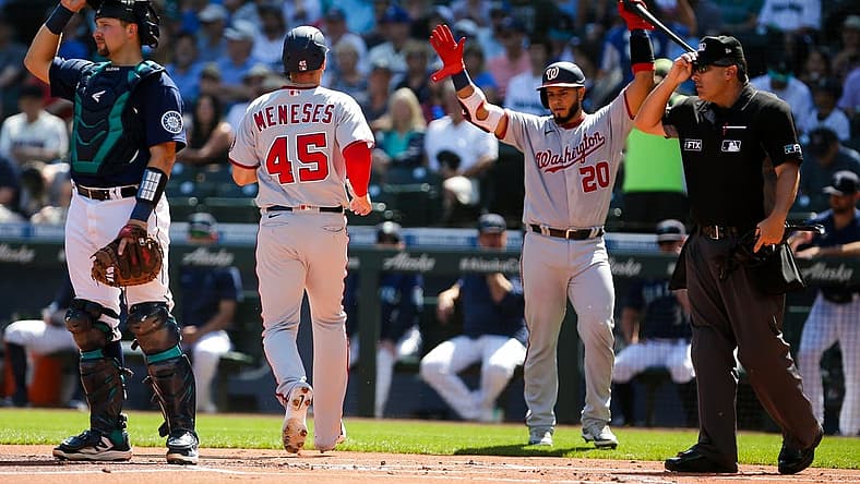 Aug 24, 2022; Seattle, Washington, USA; Washington Nationals right fielder Joey Meneses (45) is greeted by catcher Keibert Ruiz (20) after scoring against the Seattle Mariners during the first inning at T-Mobile Park. Mandatory Credit: Lindsey Wasson-USA TODAY Sports
