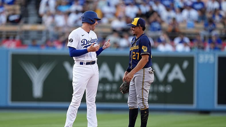 Aug 24, 2022; Los Angeles, California, USA; Los Angeles Dodgers first baseman Freddie Freeman (5) talks with Milwaukee Brewers shortstop Willy Adames (27) in the first inning at Dodger Stadium. Mandatory Credit: Kirby Lee-USA TODAY Sports