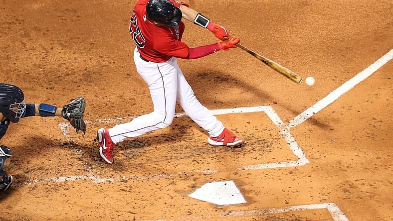 Aug 26, 2022; Boston, Massachusetts, USA; Boston Red Sox catcher Kevin Plawecki (25) hits an RBI during the second inning against the Tampa Bay Rays at Fenway Park. Mandatory Credit: Paul Rutherford-USA TODAY Sports