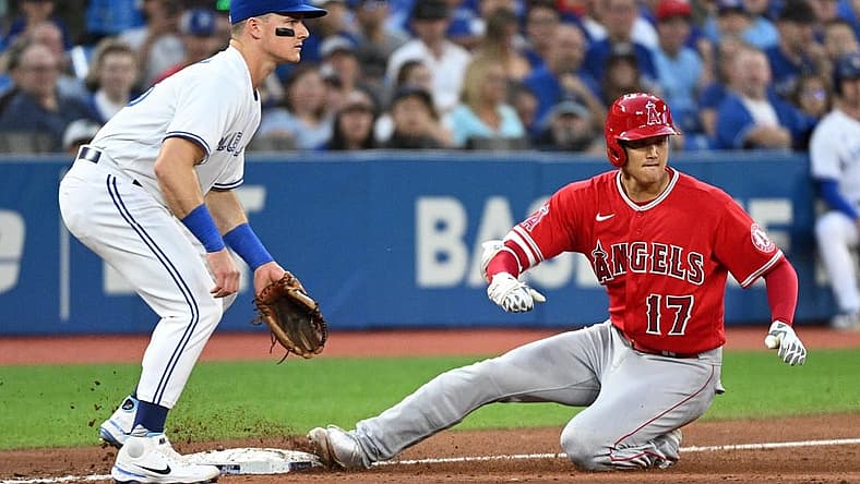 Aug 26, 2022; Toronto, Ontario, CAN;  Los Angeles Angels designated hitter Shohei Ohtani (17) slides safely into third base after hitting a two RBI triple as Toronto Blue Jays third baseman Mark Chapman (26) watches for the ball in the second inning at Rogers Centre. Mandatory Credit: Dan Hamilton-USA TODAY Sports