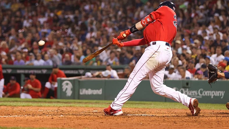 Aug 26, 2022; Boston, Massachusetts, USA; Boston Red Sox catcher Kevin Plawecki (25) hits an RBI during the fifth inning against the Tampa Bay Rays at Fenway Park. Mandatory Credit: Paul Rutherford-USA TODAY Sports