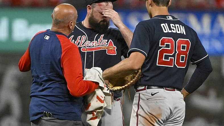 Aug 26, 2022; St. Louis, Missouri, USA; Atlanta Braves relief pitcher Jackson Stephens (53) is checked on by a trainer and first baseman Matt Olson (28) after he was hit in the head by a line drive hit by St. Louis Cardinals third baseman Brendan Donovan (not pictured) during the ninth inning at Busch Stadium. Mandatory Credit: Jeff Curry-USA TODAY Sports
