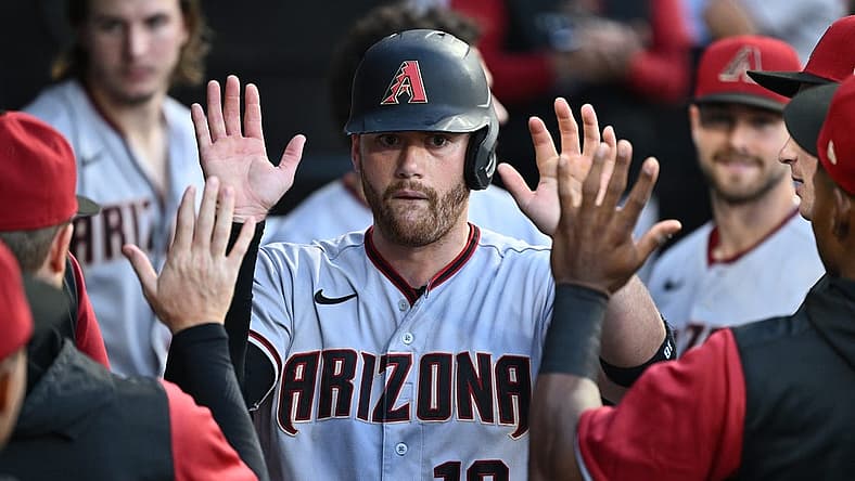 Aug 27, 2022; Chicago, Illinois, USA; Arizona Diamondbacks catcher Carson Kelly (18) celebrates in the dugout after scoring on a pass ball in the second inning against the Chicago White Sox at Guaranteed Rate Field. Mandatory Credit: Jamie Sabau-USA TODAY Sports