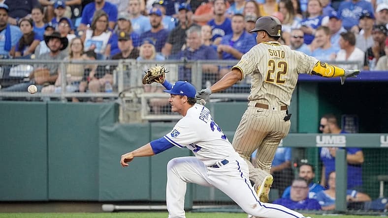 Aug 27, 2022; Kansas City, Missouri, USA; Kansas City Royals first baseman Nick Pratto (32) bobbles a throw to first base as San Diego Padres right fielder Juan Soto (22) reaches safely in the third inning at Kauffman Stadium. Mandatory Credit: Denny Medley-USA TODAY Sports