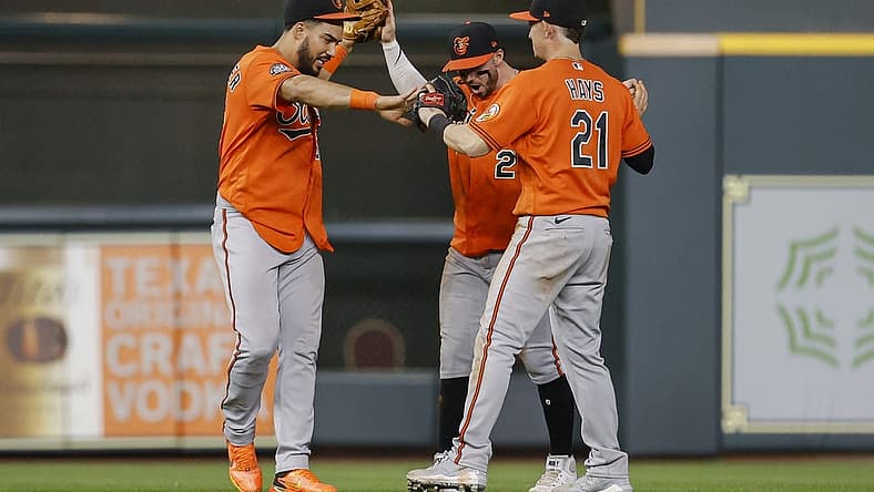 Aug 27, 2022; Houston, Texas, USA; Baltimore Orioles left fielder Anthony Santander (25) celebrates with center fielder Ryan McKenna (26) and right fielder Austin Hays (21) after the Orioles defeated the Houston Astros at Minute Maid Park. Mandatory Credit: Troy Taormina-USA TODAY Sports