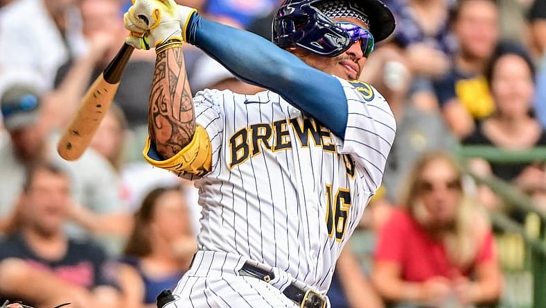 Aug 28, 2022; Milwaukee, Wisconsin, USA; Milwaukee Brewers second baseman Kolten Wong (16) hits a 2-run home run in the fifth inning against the Chicago Cubs at American Family Field. Mandatory Credit: Benny Sieu-USA TODAY Sports
