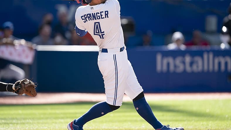 Aug 28, 2022; Toronto, Ontario, CAN; Toronto Blue Jays center fielder George Springer (4) hits a home run against the Los Angeles Angels during the ninth inning at Rogers Centre. Mandatory Credit: Nick Turchiaro-USA TODAY Sports