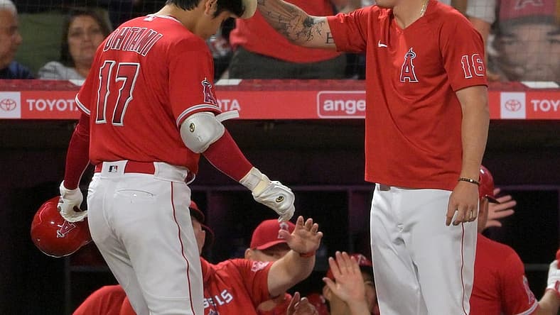 Aug 29, 2022; Anaheim, California, USA; Los Angeles Angels designated hitter Shohei Ohtani (17) has the home run cowboy hat placed on his head by Mickey Moniak (16) after hitting a two-run home run in the fifth inning off New York Yankees starting pitcher Frankie Montas (not pictured) at Angel Stadium. Mandatory Credit: Jayne Kamin-Oncea-USA TODAY Sports