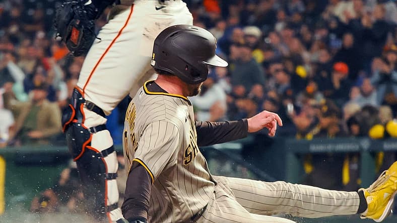 Aug 29, 2022; San Francisco, California, USA; San Diego Padres second baseman Jake Cronenworth (9) slides safely home past San Francisco Giants catcher Joey Bart (21) during the fourth inning at Oracle Park. Mandatory Credit: Kelley L Cox-USA TODAY Sports